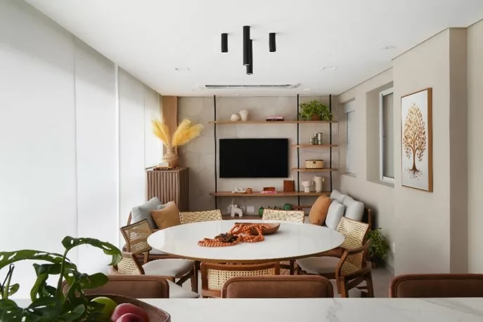 Reforma de apartamento explora dimensões generosas da varanda e agrega soluções como a inserção de um passa-prato na cozinha