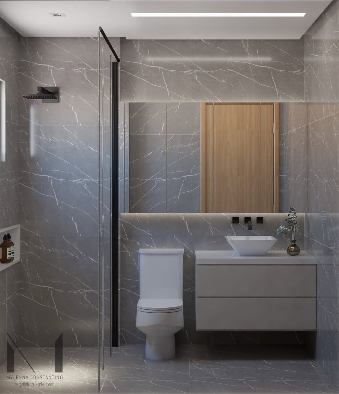 Banheiro moderno decorado em cinza e branco com porcelanato marmorizado, espelho iluminado, armário suspenso cinza e detalhes em preto fosco, destacando elegância e equilíbrio entre cores neutras.