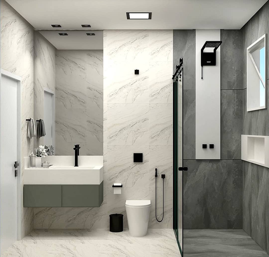 Banheiro moderno com revestimento cinza marmorizado, armário suspenso branco, cuba sobreposta, espelho amplo e porta de madeira, combinando sofisticação e aconchego em tons neutros.