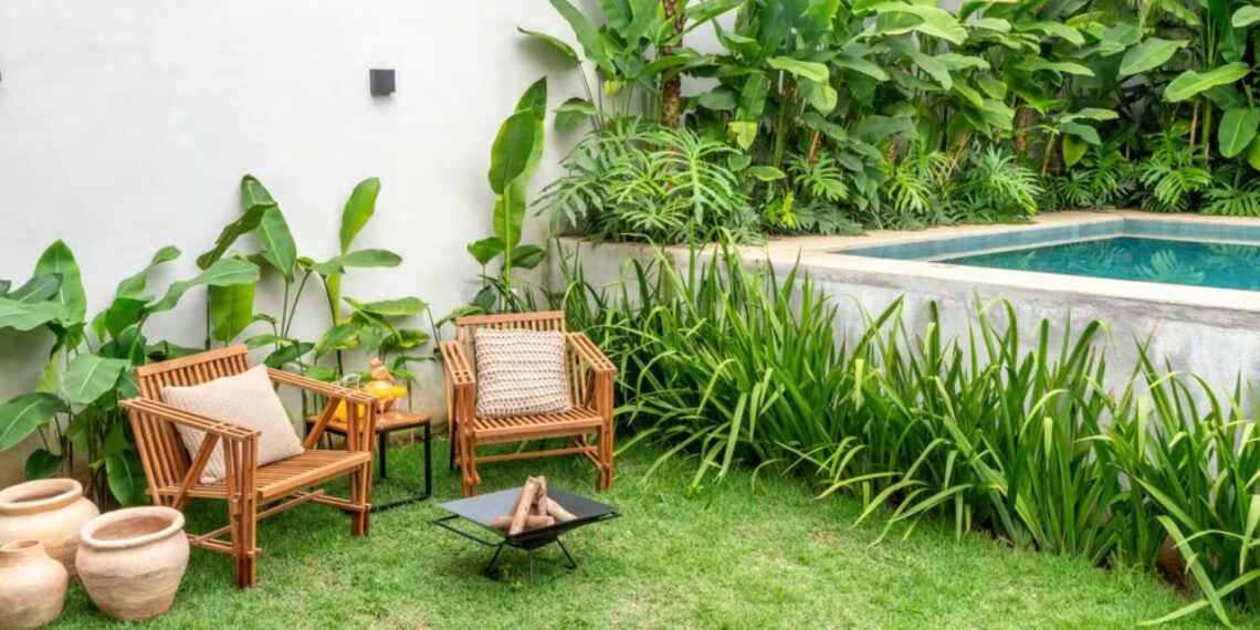 Peças de madeira de alta densidade são recomendadas para a área externa e podem ser associadas a elementos como fogo de chão. Projeto da arquiteta Isabella Nalon e do paisagista Luciano Zanardo — Foto: Julia Herman/Divulgação