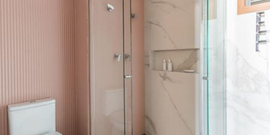 Em resumo, os nichos no box são pequenos vãos embutidos na parede, usados para guardar shampoos, sabonetes e outros itens de banho. Eles substituem as prateleiras aparentes | Projeto BMA Studio | Foto: Guilherme Pucci