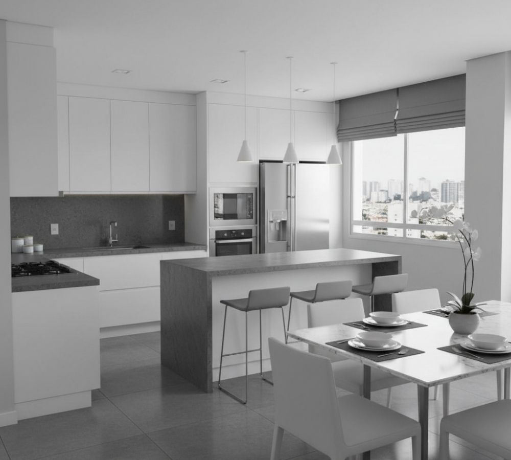 Cozinha planejada monocromática em branco e cinza, com armários brancos sem puxador, bancada e ilha em granito cinza, pendentes brancos, mesa de jantar branca com cadeiras e orquídea decorativa.