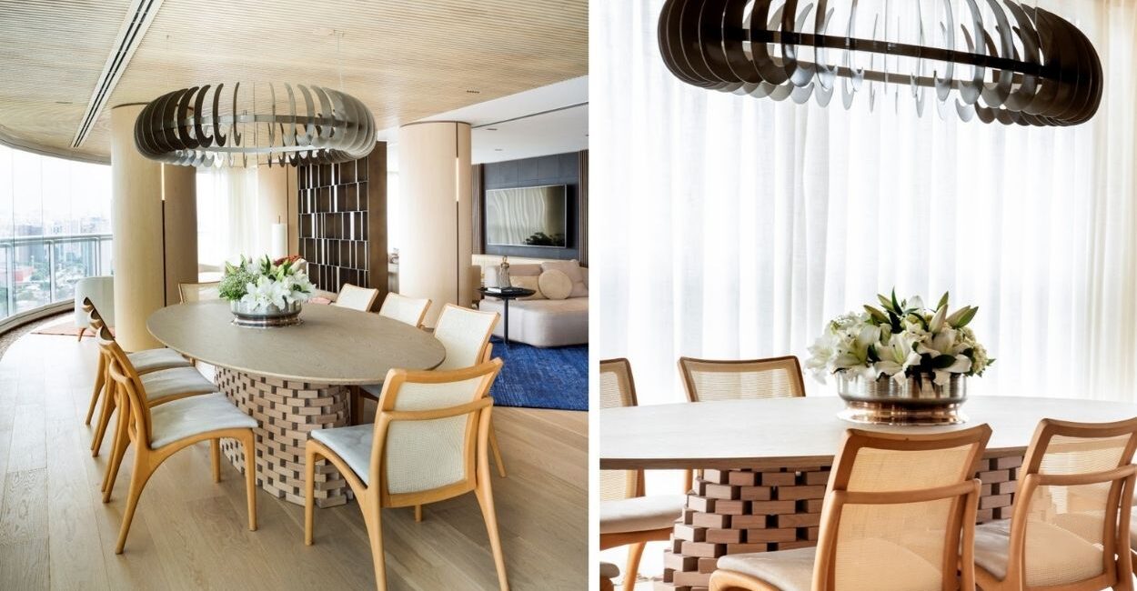 A planta circular deste projeto assinado pela arquiteta e paisagista Denise Barretto orienta o uso de móveis orgânicos em todo o apartamento, incluindo a mesa oval da sala de jantar. Como centro da mesa, um vaso arredondado com lírios brancos reforça a linguagem fluida do projeto e estabelece continuidade com as curvas presentes na arquitetura de interiores | Fotos: Rômulo Fialdini